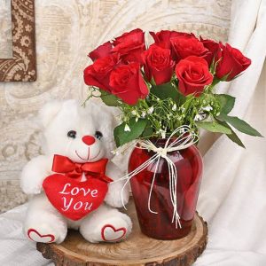 12 roses in a vase and a Teddy